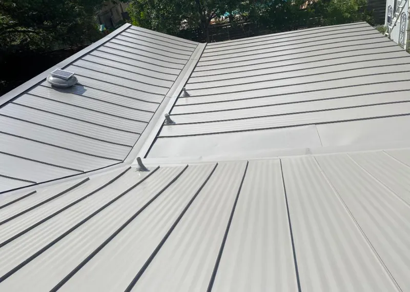 Solar attic fan installed on a metal roof for Roof Ventilation in St. John